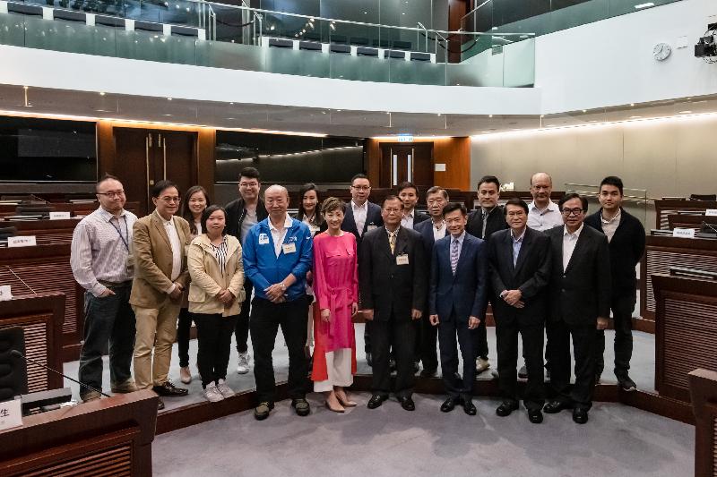 Members of the Legislative Council (LegCo) and the Eastern District Council pose for a group photo after a meeting held in the LegCo Complex today (March 19).