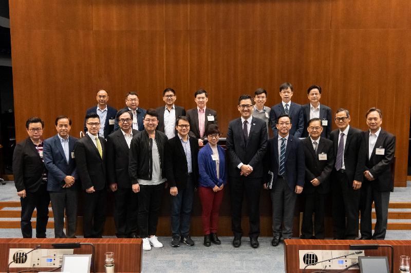 Members of the Legislative Council (LegCo) and the Tai Po District Council pose for a group photo after a meeting held in the LegCo Complex today (March 19).