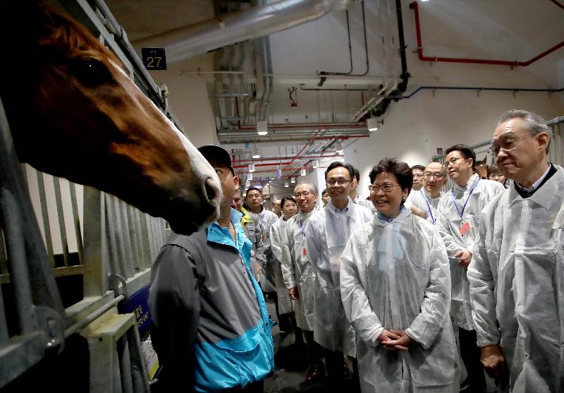 The Chief Executive, Mrs Carrie Lam, attended the opening ceremony of the first Exhibition Raceday held by the Hong Kong Jockey Club (HKJC) in collaboration with the local government at the Conghua Racecourse in Conghua, Guangzhou today (March 23). Photo shows Mrs Lam (front row, second right) visiting a stable at the HKJC Conghua Racecourse with the Director of the Hong Kong and Macao Affairs Office of the State Council, Mr Zhang Xiaoming (second row, first right); the Secretary for Constitutional and Mainland Affairs, Mr Patrick Nip (second row, second right); and the Chairman of the HKJC, Dr Anthony Chow (first row, first right), in the morning.