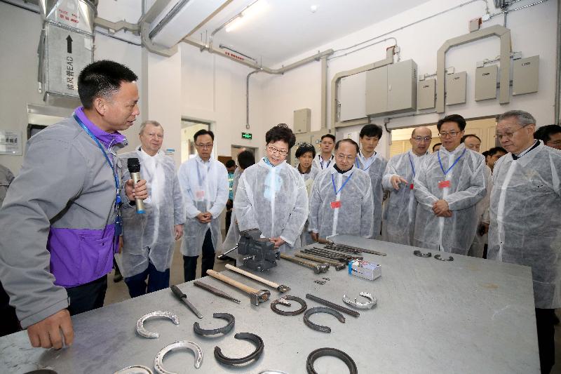 The Chief Executive, Mrs Carrie Lam, attended the opening ceremony of the first Exhibition Raceday held by the Hong Kong Jockey Club (HKJC) in collaboration with the local government at the Conghua Racecourse in Conghua, Guangzhou today (March 23). Photo shows Mrs Lam (fourth left) visiting the farrier forge at the HKJC Conghua Racecourse with the Director of the Hong Kong and Macao Affairs Office of the State Council, Mr Zhang Xiaoming (second right); the Director of the Liaison Office of the Central People's Government in the Hong Kong Special Administrative Region, Mr Wang Zhimin (fifth right); and the Chairman of the HKJC, Dr Anthony Chow (first right), in the morning.