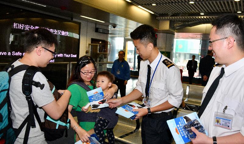 Marine Inspectors of the Marine Department distribute promotional leaflets to passengers at the waiting lounge of the Hong Kong-Macau Ferry Terminal in Sheung Wan today (March 29) to encourage them to fasten their seat belts at the appropriate time to ensure a safer sea journey.