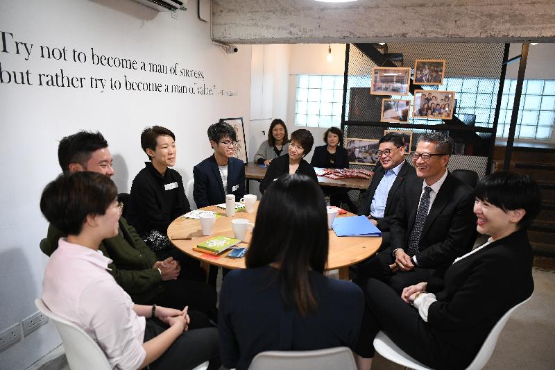 The Financial Secretary, Mr Paul Chan (second right), today (April 3) visits a co-working space in Central and Western District and exchanges views with young entrepreneurs. Also present are the Chairman of the Central and Western District Council, Mr David Yip (third right), and the District Officer (Central and Western), Mrs Susanne Wong (first right). 