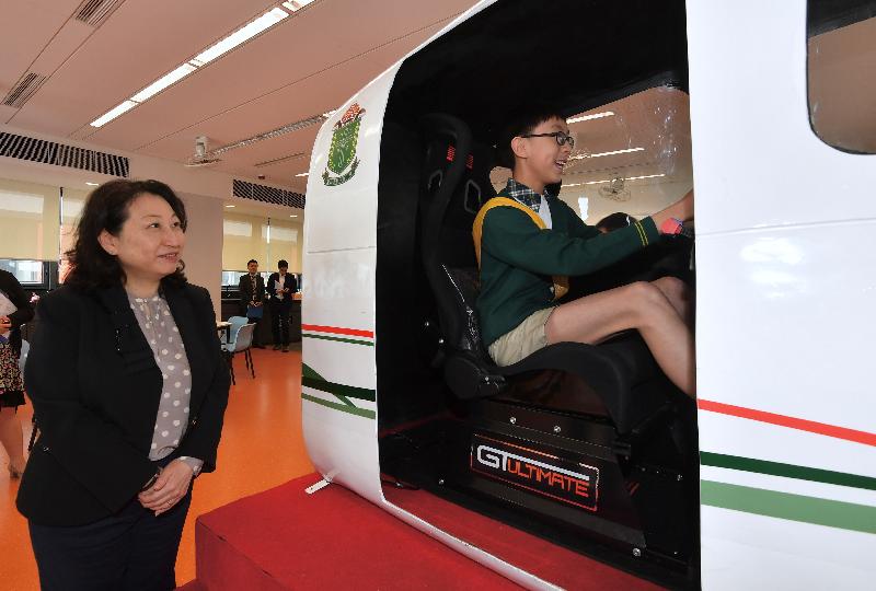 律政司司長鄭若驊資深大律師（左）今日（五月三日）到訪九龍城的聖公會聖十架小學，
觀看學生在模擬小型飛機駕駛艙內的示範。

 