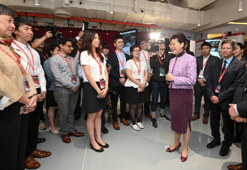 The Chief Executive, Mrs Carrie Lam, attended the Grand Opening of ASM Pacific Technology Hong Kong Office today (May 6). Photo shows Mrs Lam (front row, second right) chatting with young engineers after the opening.