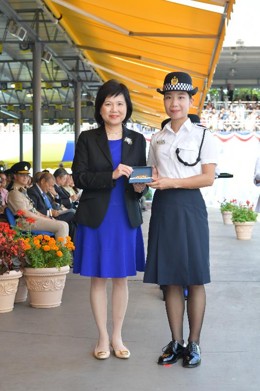 The Correctional Services Department held a passing-out parade at the Staff Training Institute in Stanley today (May 10). Photo shows the Permanent Secretary for Security, Mrs Marion Lai (left), presenting a Best Recruit Award, the Golden Whistle, to Assistant Officer II Ms Chan Shuk-mui.