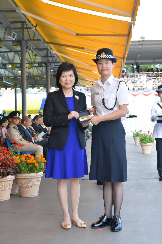 The Correctional Services Department held a passing-out parade at the Staff Training Institute in Stanley today (May 10). Photo shows the Permanent Secretary for Security, Mrs Marion Lai (left), presenting a Best Recruit Award, the Golden Whistle, to Assistant Officer II Ms Hui Fun-sum.