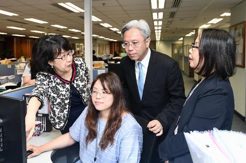 The Secretary for the Civil Service, Mr Joshua Law, visited the Companies Registry today (May 15). Photo shows Mr Law (second right) being briefed by colleagues on how they process applications for incorporation of local companies and the registration of non-Hong Kong companies. Looking on is the Registrar of Companies, Ms Ada Chung (first left).