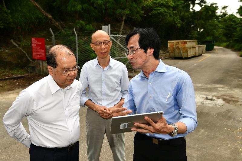 The Chief Secretary for Administration, Mr Matthew Cheung Kin-chung, accompanied by the Secretary for the Environment, Mr Wong Kam-sing, visited a skip storage area at Siu Lang Shui Road in Tuen Mun today (May 15). Photo shows Mr Cheung (left) and Mr Wong (centre) receiving a briefing from the Deputy Director of Environmental Protection, Mr Elvis Au (right), on the situation there.