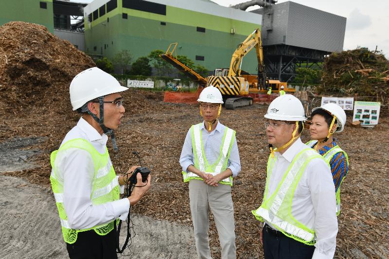 The Chief Secretary for Administration, Mr Matthew Cheung Kin-chung (third left), accompanied by the Secretary for the Environment, Mr Wong Kam-sing (second left), visits the temporary yard waste disposal and treatment site near T·PARK today (May 15) to inspect the disposal progress of tree waste collected after the passage of Super Typhoon Mangkhut.