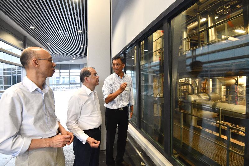 The Chief Secretary for Administration, Mr Matthew Cheung Kin-chung (centre), accompanied by the Secretary for the Environment, Mr Wong Kam-sing (left), visited T·PARK today (May 15). Photo shows them being briefed by an EPD staff member on the operations of the sludge treatment plant.