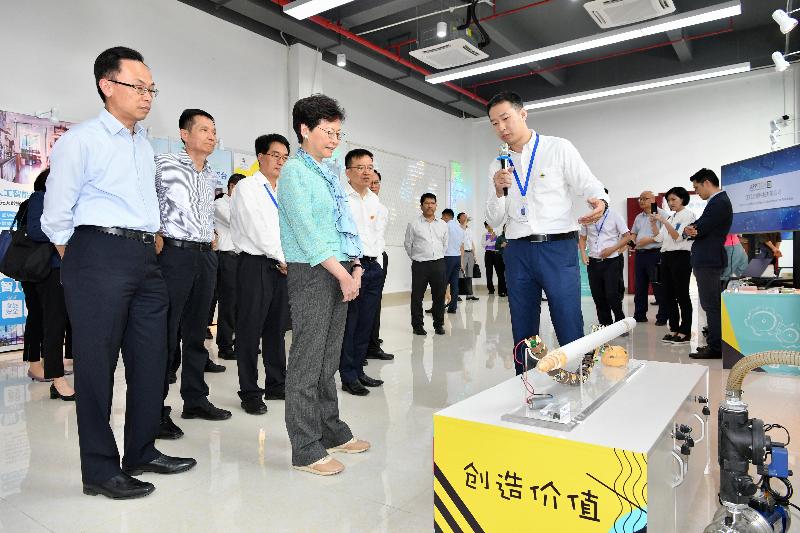 The Chief Executive, Mrs Carrie Lam visited the Guangdong-Hong Kong-Macao-Taiwan scientific and technological enterprise incubator at Inno Valley in Jiangmen today (May 17). Photo shows Mrs Lam (first row, first left) receiving a briefing from a representative of an enterprise. Also attending were the Secretary for Constitutional and Mainland Affairs, Mr Patrick Nip (second row, first left) and the Director General of the Hong Kong and Macao Affairs Office of the People's Government of Guangdong Province, Mr Liao Jingshan (second row, second left).