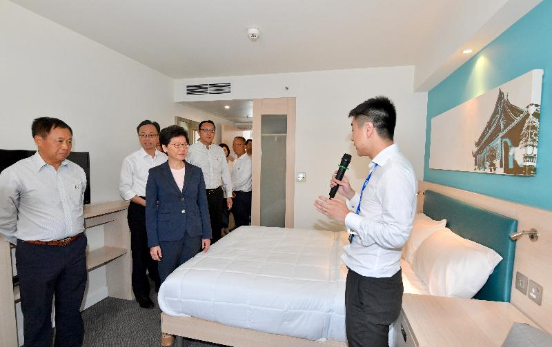 The Chief Executive, Mrs Carrie Lam, visited CIMC Modular Building Systems plant in Jiangmen today (May 18). Photo shows Mrs Lam (second left) touring the hotel room in the display centre. Accompanying her is the Secretary for Constitutional and Mainland Affairs, Mr Patrick Nip (third left).