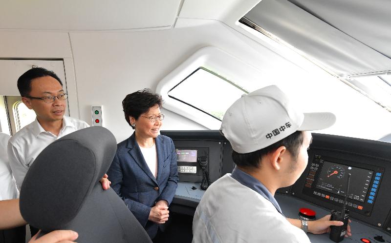 The Chief Executive, Mrs Carrie Lam, toured the CRRC Guangdong depot in Jiangmen today (May 18). Photo shows Mrs Lam (centre), accompanied by the Secretary for Constitutional and Mainland Affairs, Mr Patrick Nip (first left), viewing a train's driving cab.
