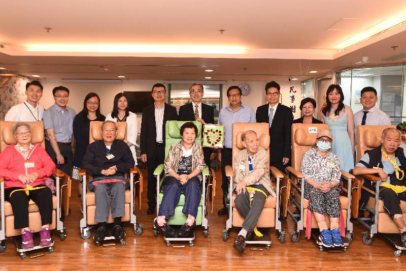 The Secretary for Financial Services and the Treasury, Mr James Lau (back row, centre), visited the Methodist Rejoice Centre today (May 20). He toured its facilities and chatted with some elderly people. Joining him was the Under Secretary for Financial Services and the Treasury, Mr Joseph Chan (fourth right).