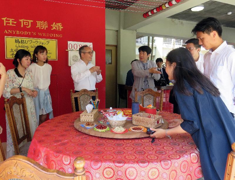 The Secretary for Home Affairs, Mr Lau Kong-wah, continued his visit to Japan today (May 23). Photo shows Hong Kong artist Alexander Hui (fourth left) introducing to Mr Lau (third left) the work "Wedding Shop" by Hong Kong artists in the Setouchi Triennale 2019 in Megijima.