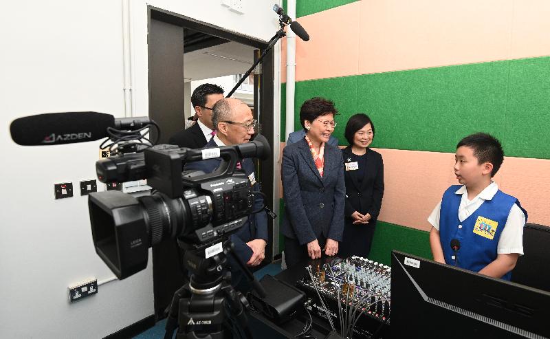 The Chief Executive, Mrs Carrie Lam, visited Po Leung Kuk Stanley Ho Sau Nan Primary School in the Kai Tak Development Area this afternoon (May 27). Picture shows Mrs Lam (third right) and the Acting Secretary for Education, Dr Choi Yuk-lin (second right), being briefed by students on campus TV production.