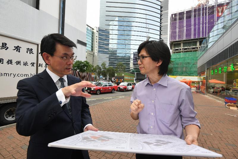 The Secretary for Commerce and Economic Development, Mr Edward Yau, visited Sha Tin District today (June 6). Photo shows Mr Yau (left) touring the Shek Mun Business Area and being briefing by a representative of the Planning Department to get a better understanding of the district affairs.