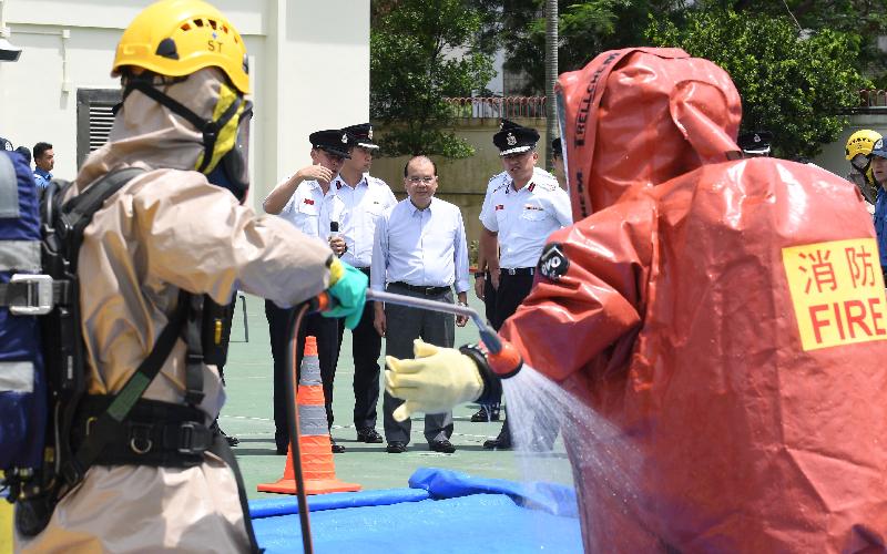The Chief Secretary for Administration, Mr Matthew Cheung Kin-chung, visited Sha Tin Fire Station this afternoon (June 8). Photo shows Mr Cheung (second right), accompanied by the Director of Fire Services, Mr Li Kin-yat (first right), viewing a demonstration by the Hazardous Material Team of the Fire Services Department.