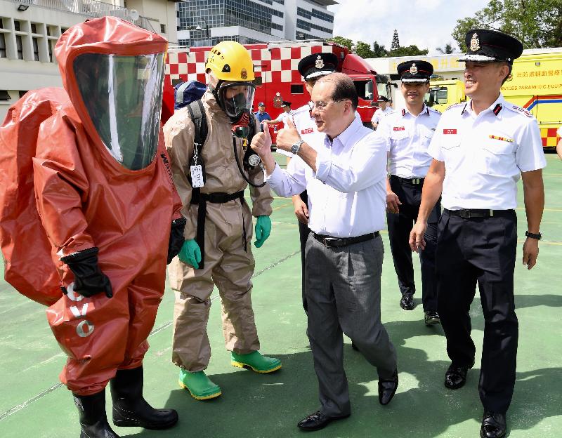 The Chief Secretary for Administration, Mr Matthew Cheung Kin-chung, visited Sha Tin Fire Station this afternoon (June 8). Photo shows Mr Cheung (front row, second right), accompanied by the Director of Fire Services, Mr Li Kin-yat (front row, first right), learning about the work of the HazMat (hazardous materials) Team of the Fire Services Department.