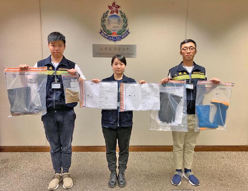 The Immigration Department mounted a territory-wide anti-illegal worker operation codenamed "Twilight" from June 10 to 13. Photo shows officers holding items seized during the operation.
