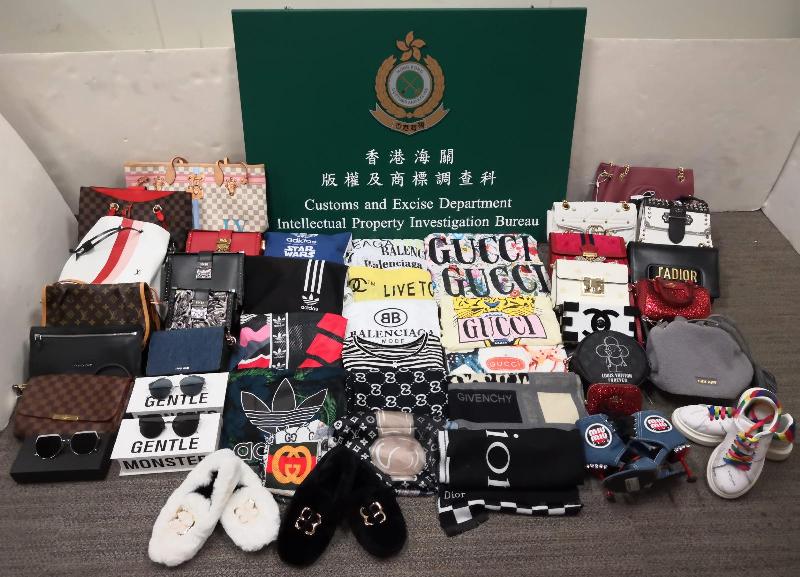 Hong Kong Customs conducted an operation codenamed "Eagle Web" from June 11 until yesterday (June 23) against the sale of counterfeit goods by shops doing promotion through Internet platforms. A total of 236 items of suspected counterfeit clothing, shoes and handbags with an estimated market value of about $110,000 were seized. Photo shows some of the suspected counterfeit goods seized.