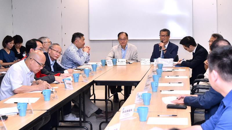 The Financial Secretary, Mr Paul Chan (back row, right), accompanied by the District Officer (Sai Kung), Mr David Chiu (back row, left), this afternoon (June 25) meets with the Chairman of the Sai Kung District Council (SKDC), Mr George Ng (back row, centre), and members of the SKDC to exchange views on various livelihood and development issues in the district.