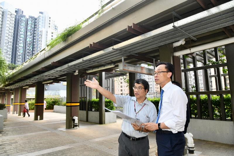 The Secretary for Constitutional and Mainland Affairs, Mr Patrick Nip (right), being briefed by a government colleague on the planning and ancillary facilities of Shui Chuen O Estate in Sha Tin today (June 27) to learn about the development of the area.