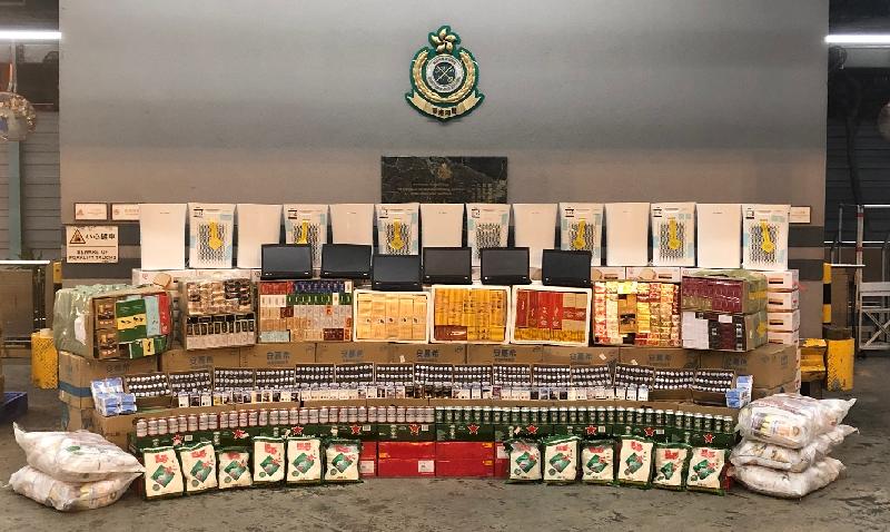 Hong Kong Customs yesterday (July 8) seized about 120 000 suspected illicit cigarettes, 72 litres of suspected duty-not-paid liquor and a batch of suspected smuggled food and electronic products with an estimated market value of about $600,000 in total and a duty potential of about $240,000 at the Kwai Chung Customhouse Cargo Examination Compound.