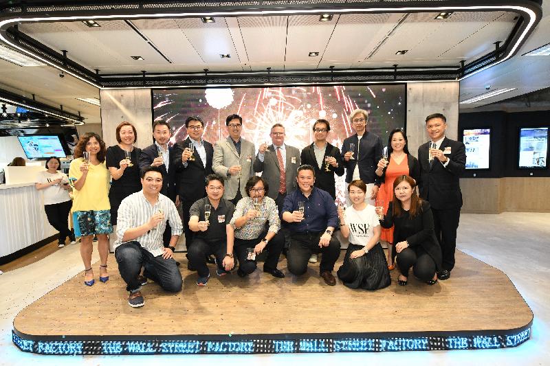 The Director-General of Investment Promotion, Mr Stephen Phillips (back row, fifth right), is pictured with the Founder and Chairman of TNG, Mr Alex Kong (front row, third right), and guests at the opening ceremony of the Wall Street Factory today (July 15).