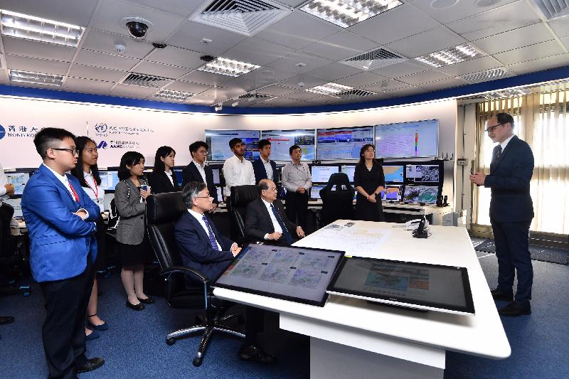 The Chief Secretary for Administration, Mr Matthew Cheung Kin-chung, visited the Hong Kong Observatory (HKO) today (July 15). Photo shows Mr Cheung (front row, right), accompanied by the Director of the HKO, Mr Shun Chi-ming (front row, left), being briefed by the Acting Assistant Director of the HK Observatory (Radiation Monitoring and Assessment), Mr Ma Wai-man (first right), on HKO's work on monitoring radiation levels.
