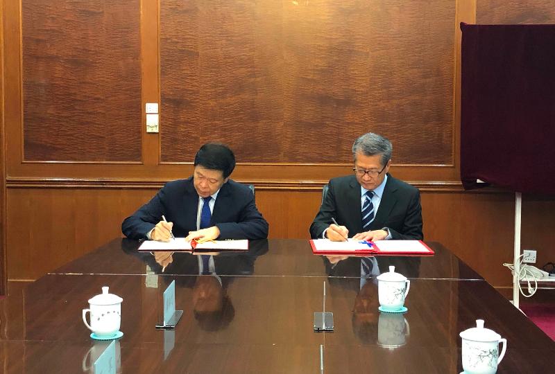 The Financial Secretary, Mr Paul Chan (right), signs the Fifth Protocol to the Arrangement between the Mainland of China and the Hong Kong Special Administrative Region for the Avoidance of Double Taxation and the Prevention of Fiscal Evasion with respect to Taxes on Income with the Commissioner of the State Taxation Administration, Mr Wang Jun (left), in Beijing today (July 19).