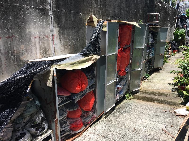 Hong Kong Customs conducted an operation against the sale of counterfeit items at a mobile hawker stall on July 27. About 6 900 items of suspected counterfeit goods, including clothing, caps and shoes, with an estimated market value of about $420,000 were seized. Photo shows some of the mobile storage facilities in alleys near the mobile hawker stall.