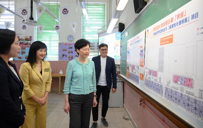 The Chief Executive, Mrs Carrie Lam, accompanied by the Secretary for Transport and Housing, Mr Frank Chan Fan, visited a transitional housing project operated by Lok Sin Tong today (August 9). Photo shows Mrs Lam (second right) and the Chairlady of the Lok Sin Tong Benevolent Society, Kowloon, Dr Yang Xiaoling (second left), being briefed by the Chief Executive of the Lok Sin Tong Benevolent Society, Kowloon, Ms Alice Lau (first left), at Lok Sin Tong Primary School on the project to convert the school into transitional housing.