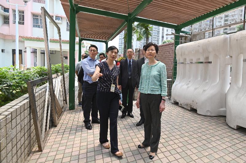 The Chief Executive, Mrs Carrie Lam (front row, right), inspects the damage to the Wong Tai Sin Disciplined Services Quarters by mobs earlier. Looking on are the Secretary for Transport and Housing, Mr Frank Chan Fan (second row, right), and the Government Property Administrator, Mr Vincent Liu (second row, left).