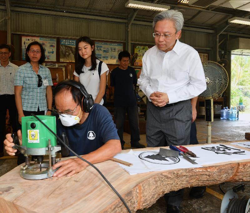 The Secretary for the Civil Service, Mr Joshua Law, visited the Tai Tong Forest Nursery of the Agriculture, Fisheries and Conservation Department in Yuen Long today (August 14). Photo shows Mr Law (first right) watching the production of a wooden product for a country park at the Tai Tong Regional Workshop.