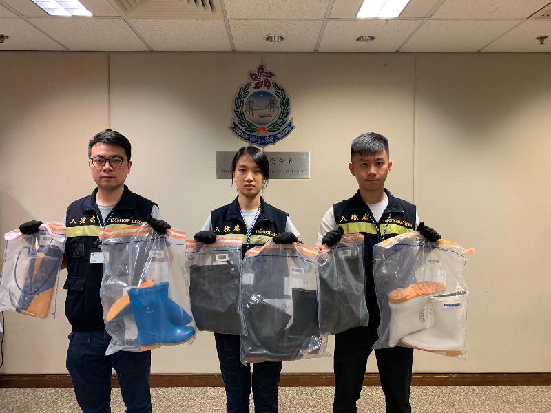 The Immigration Department mounted territory-wide anti-illegal worker operations codenamed "Twilight", "Greenlane" and "Interrupt" from September 9 to 12. Photo shows officers holding items seized during the operation.