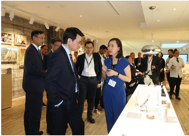 The Secretary for Commerce and Economic Development, Mr Edward Yau (left), today (September 17, US West Coast time) toured the "Co-creating Hong Kong: a design+ exhibition" in San Francisco, the United States, and was briefed by a designer from Hong Kong about her work.