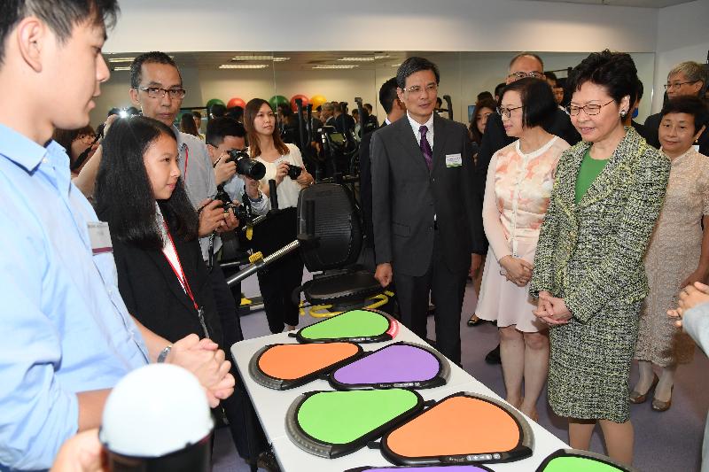 The Chief Executive, Mrs Carrie Lam (first right), accompanied by the Secretary for Food and Health, Professor Sophia Chan (second right), tours around the Kwai Tsing District Health Centre to learn more about its facilities and services after officiating at the opening ceremony today (September 24). Photo shows Mrs Lam seeing the force plates for training on fall prevention.