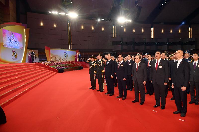 The Acting Chief Executive, Mr Matthew Cheung Kin-chung (third right); Deputy Director of the Liaison Office of the Central People's Government in the Hong Kong Special Administrative Region (HKSAR) Mr Chen Dong (fourth right); the Commissioner of the Ministry of Foreign Affairs of the People's Republic of China in the HKSAR, Mr Xie Feng (third left); the Acting Chief Justice of the Court of Final Appeal, Mr Roberto Alexandre Vieira Ribeiro (second right); the Commander-in-chief of the Chinese People's Liberation Army Hong Kong Garrison, Major General Chen Daoxiang (second left); the Political Commissar of the Chinese People's Liberation Army Hong Kong Garrison, Major General Cai Yongzhong (first left); and the Acting Financial Secretary, Mr Wong Kam-sing (first right), together with Principal Officials and guests, watch the flag-raising ceremony in celebration of the 70th anniversary of the founding of the People's Republic of China this morning (October 1).
