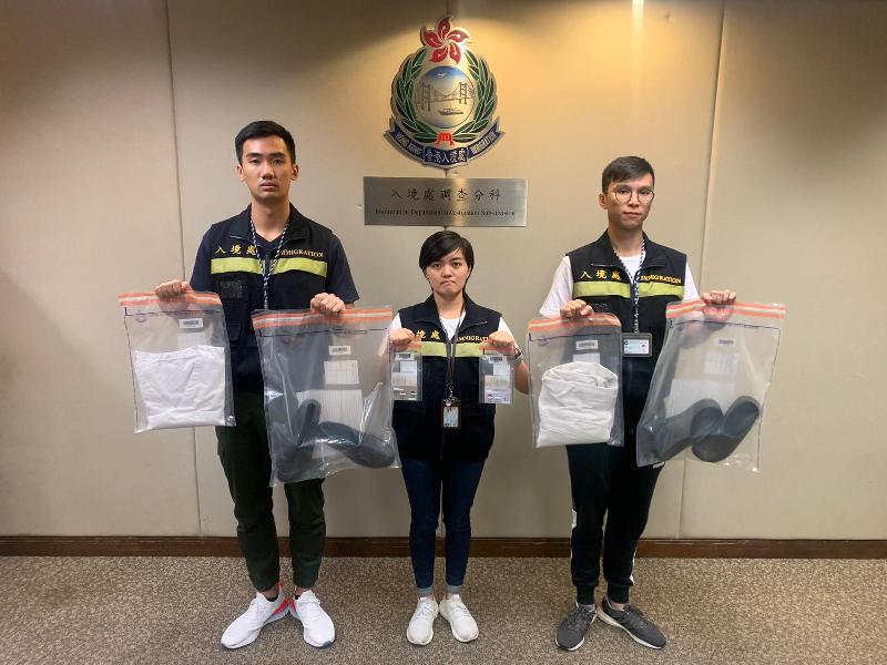 The Immigration Department mounted an anti-illegal worker operation codenamed "Twilight" yesterday (October 28). Photo shows officers holding items seized during the operation.
