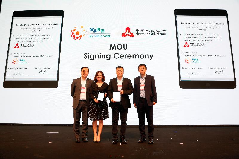 The Chief Executive Officer of the Hong Kong Trade Finance Platform Company Limited, Ms Haster Tang (second left), and Deputy Director-General of the Institute of Digital Currency of the People's Bank of China and Director of Shenzhen Fintech Institute, Mr Di Gang (second right), signed the Memorandum of Understanding to conduct a Proof-of-Concept trial today (November 6). The signing ceremony was witnessed by the Executive Director (Financial Infrastructure) of the Hong Kong Monetary Authority, Mr Colin Pou (first left), and Director-General of the Institute of Digital Currency of the People's Bank of China, Mr Mu Changchun (first right).