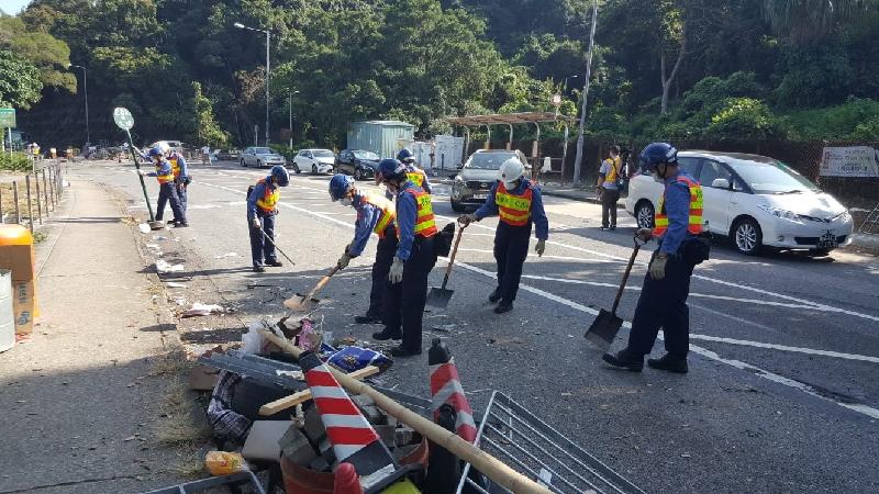 Members of the public and various Government departments worked together today (November 16) to clear a number of blocked roads and relevant Government departments spared no effort in repairing damaged facilities and arranged alternative services for members of the public to restore operation in society as soon as possible. Picture shows members of the Civil Aid Service clearing Tai Po Road near Chinese University of Hong Kong.