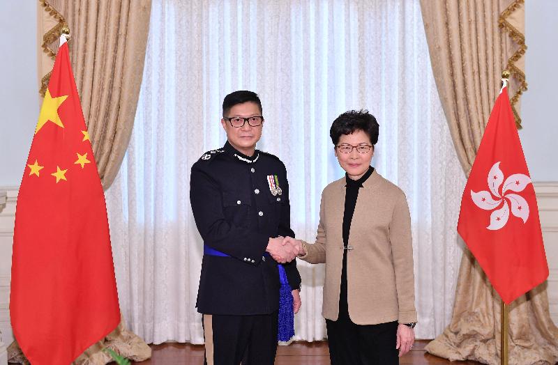 The Chief Executive, Mrs Carrie Lam (right), poses with the new Commissioner of Police, Mr Tang Ping-keung (left), today (November 19).