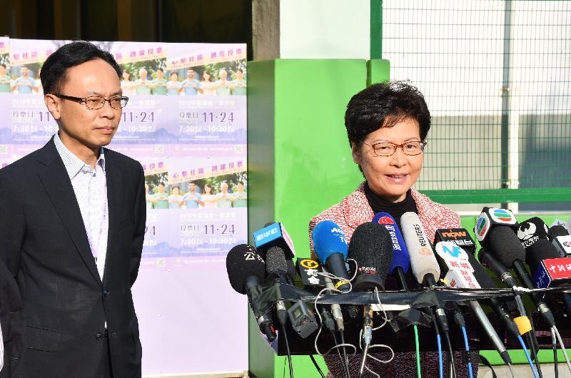The Chief Executive, Mrs Carrie Lam (right), today (November 24) meets the media after casting her vote in the 2019 District Council Ordinary Election.

