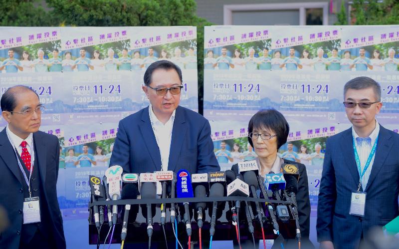 The Chairman of the Electoral Affairs Commission, Mr Justice Barnabas Fung Wah (second left), Commission members Mr Arthur Luk, SC (first left) and Professor Fanny Cheung (second right), meet the media at the polling station at Ma Tau Chung Government Primary School (Hung Hom Bay) this morning (November 24).
