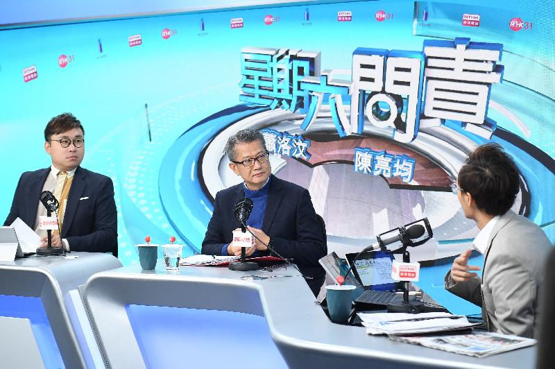 The Financial Secretary, Mr Paul Chan (centre), attends Radio Television Hong Kong's programme "Accountability" this morning (December 7).