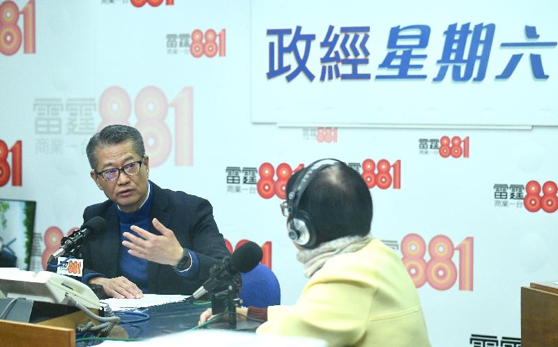 The Financial Secretary, Mr Paul Chan (left), attends Commercial Radio's programme "Saturday Forum" this morning (December 7).