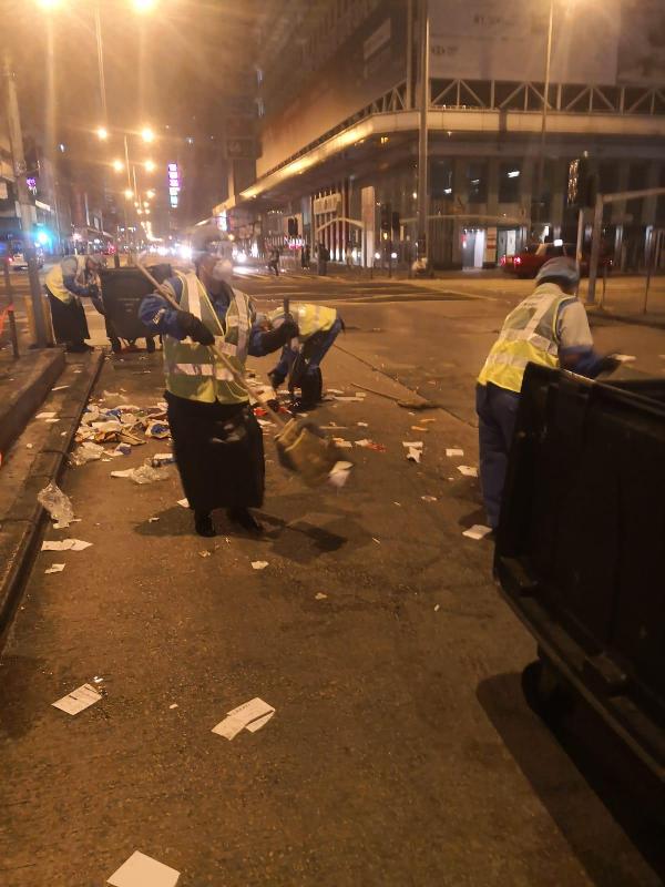 Picture shows cleansing workers of Food and Environmental Hygiene Department contractors clean up the streets in Mong Kok this morning (December 16) after the large-scale public event there.