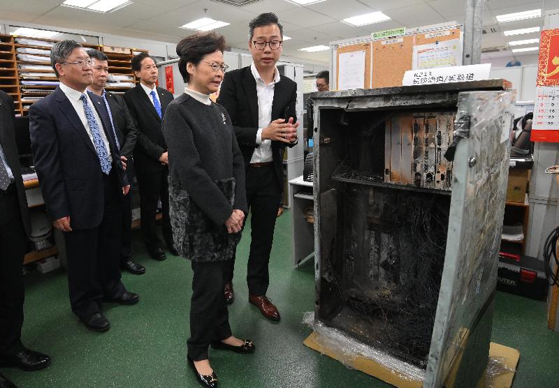 The Chief Executive, Mrs Carrie Lam, visited the Electrical and Mechanical Services Department (EMSD) and the Transport Department today (December 30) to learn more about the measures and recovery work taken by the two departments in response to the protests and vandalistic acts in recent months. Photo shows Mrs Lam (second right) being briefed by the EMSD's engineer, Mr Keith Chan (first right), on the traffic light repair work. Looking on is Acting Director of Electrical and Mechanical Services, Mr Pang Yiu-hung (first left).