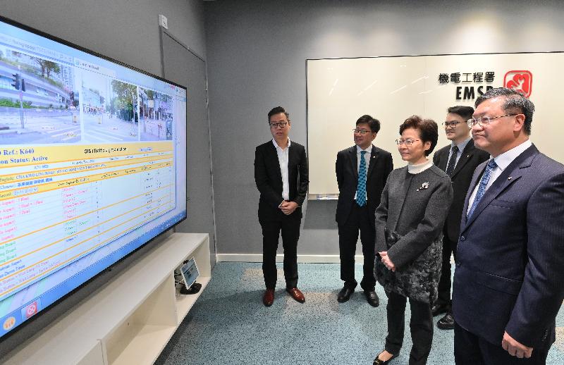 The Chief Executive, Mrs Carrie Lam, visited the Electrical and Mechanical Services Department (EMSD) and the Transport Department today (December 30) to learn more about the measures and recovery work taken by the two departments in response to the protests and vandalistic acts in recent months. Photo shows Mrs Lam (third left), accompanied by the Acting Director of Electrical and Mechanical Services, Mr Pang Yiu-hung (first right), receiving a briefing on the operation of the traffic light monitoring system.